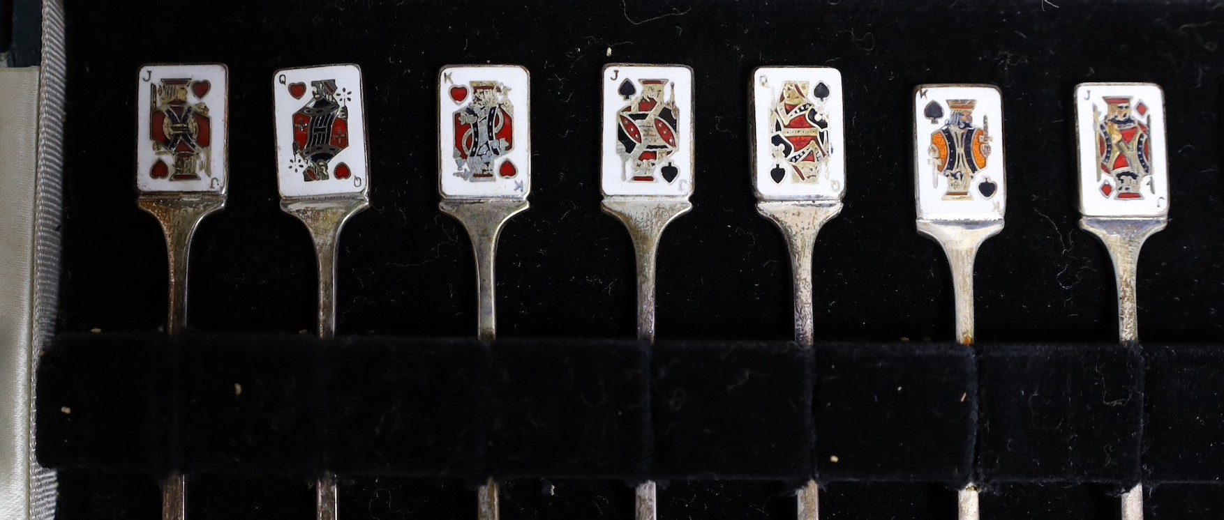 A cased set of twelve early 1960's silver and enamel cocktail sticks, by Garrard & Co, with playing card terminals, Birmingham, 1961.